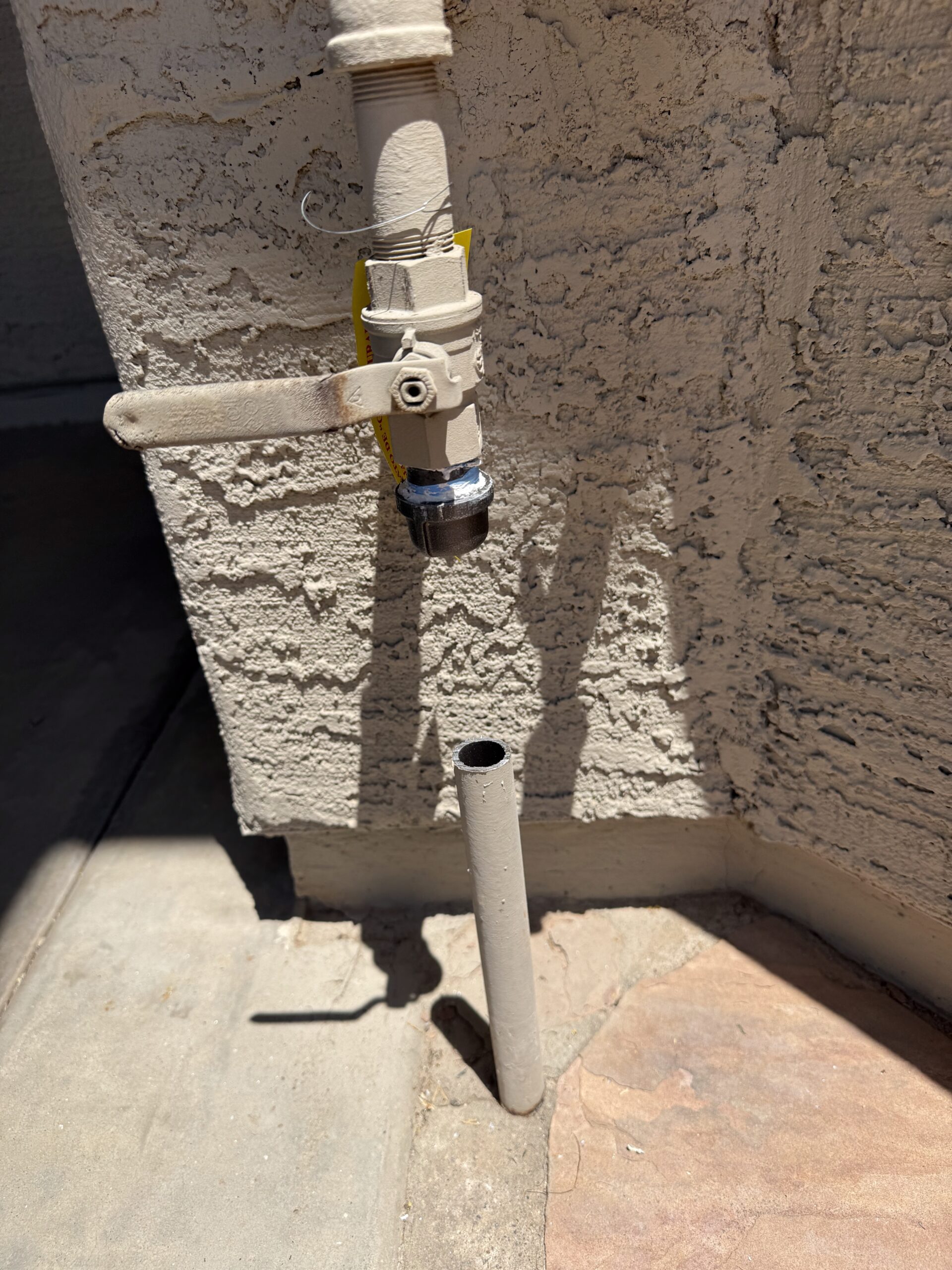 Underground gas line capped at a residential property, showcasing a valve and exposed pipe, relevant to Edge Plumbing's gas line services in Peoria, AZ.