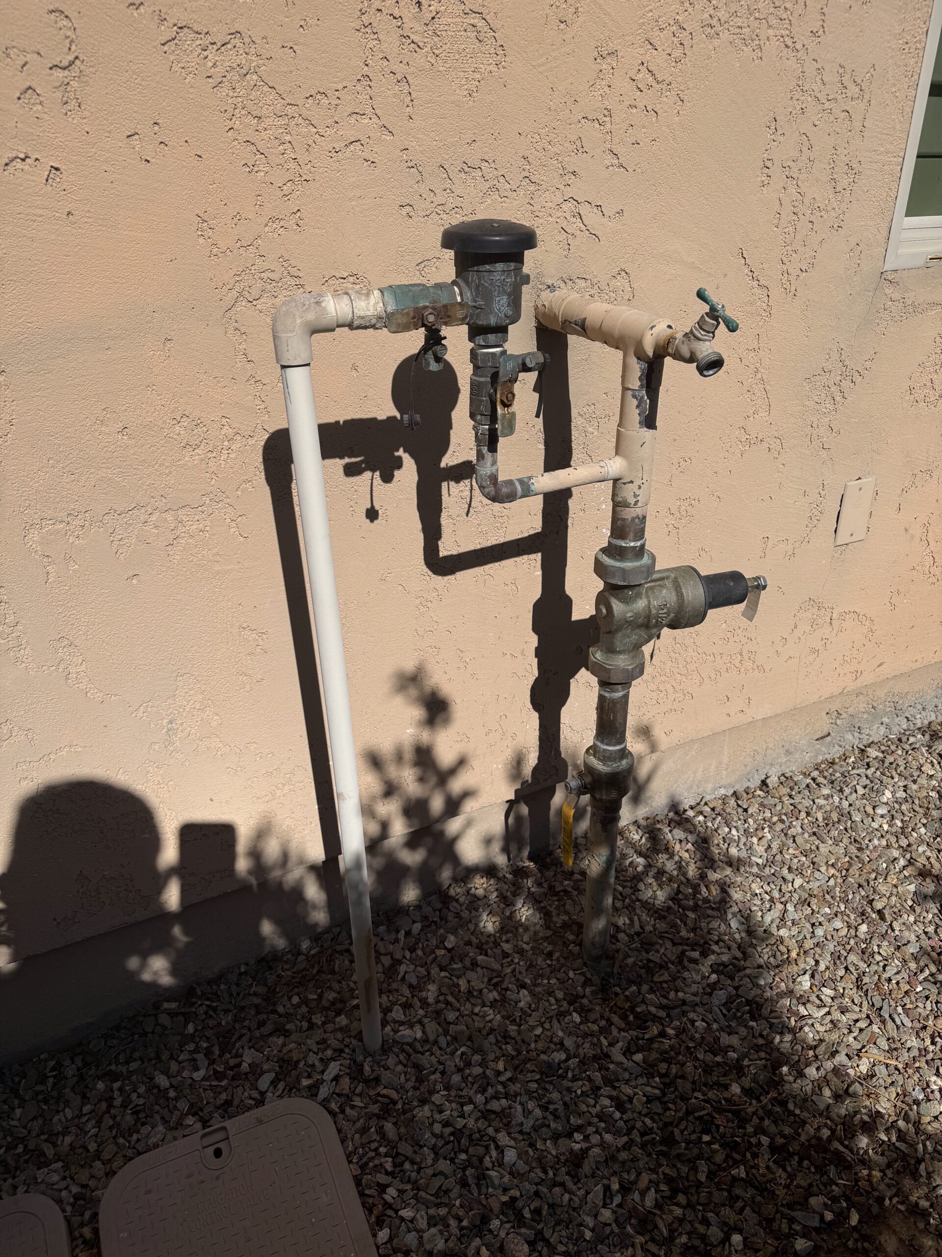 Main water supply valve and piping system installed outside a residential property in Peoria, AZ, illustrating plumbing infrastructure relevant to Edge Plumbing services.