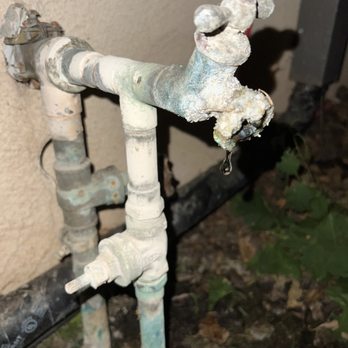 Corroded plumbing valve with water dripping, illustrating common plumbing issues like leaks, relevant to seasonal plumbing maintenance.