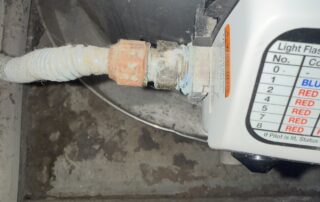 Tankless water heater installation showing connection pipe and control panel in Surprise, AZ.