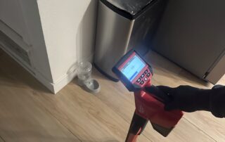 Sewer line locating tool in use, detecting plumbing issues in a home setting, relevant to expert sewer repair services in Surprise, AZ.